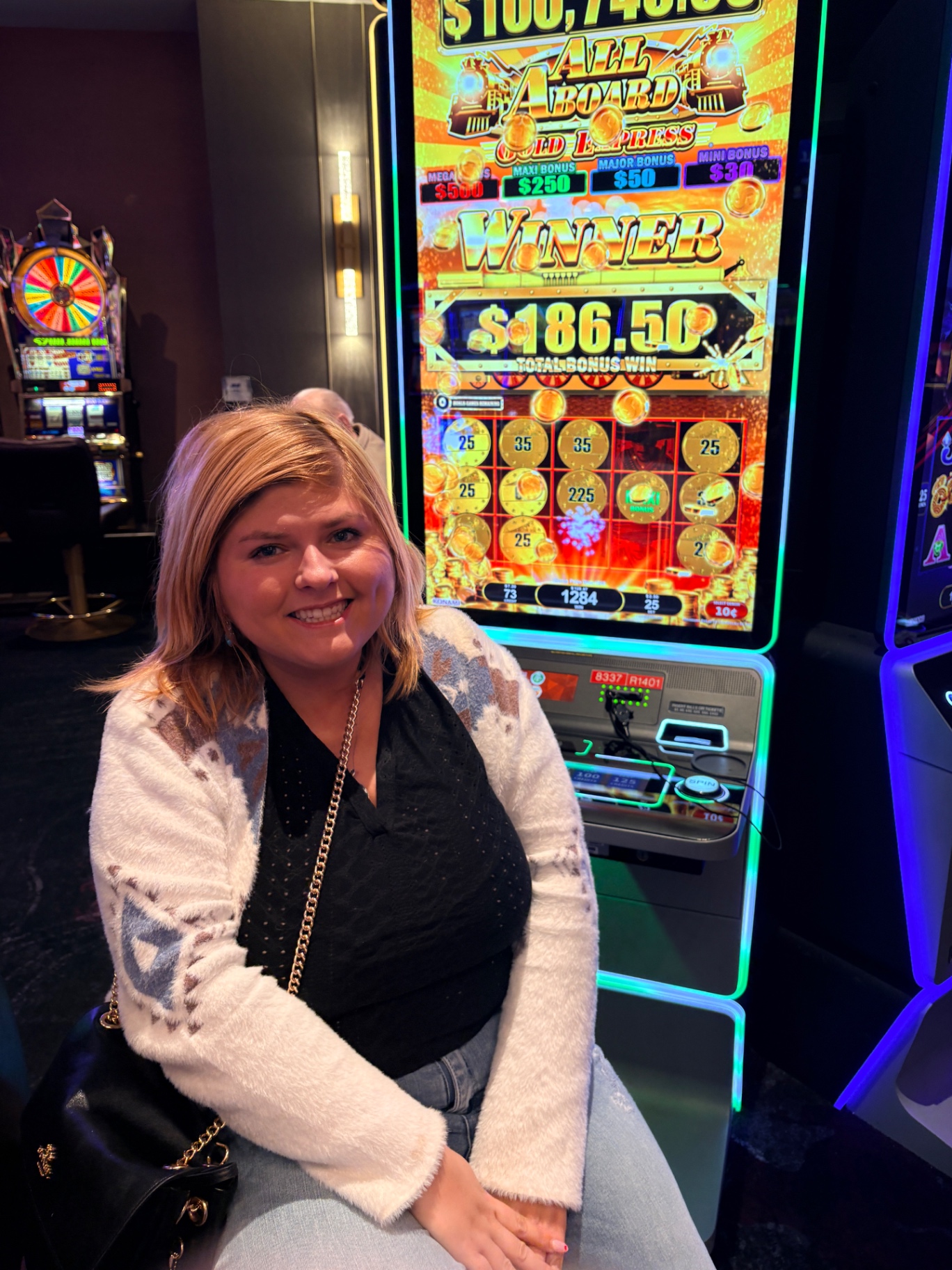 Naomi smiling in front of a Las Vegas slot machine showing a $186.50 win